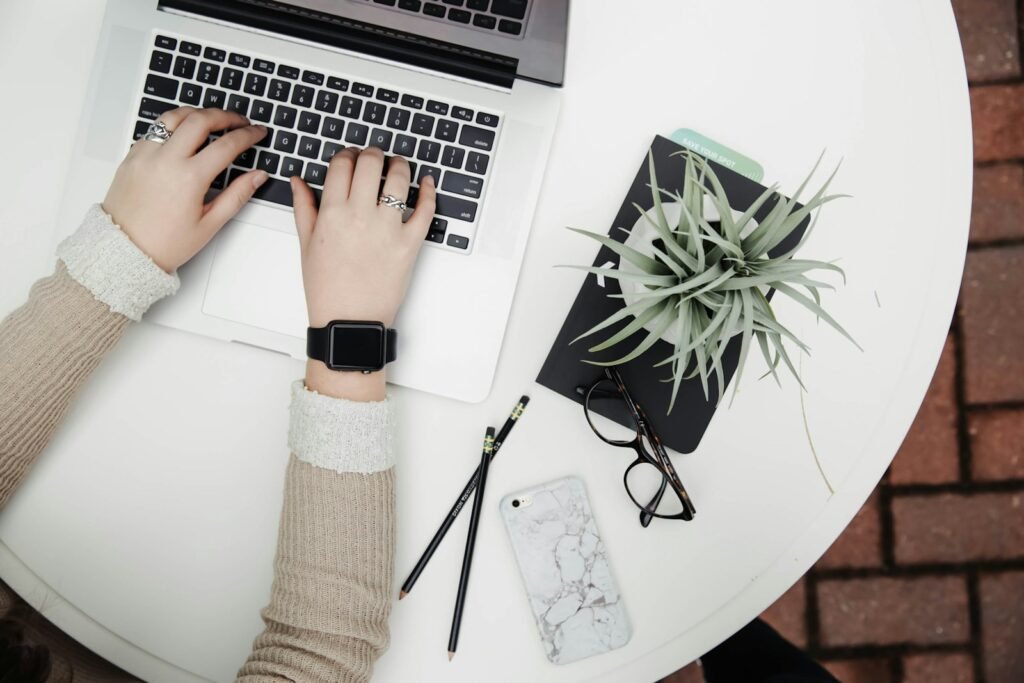 person using laptop computer beside aloe vera. How to write a book in 30 days